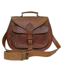 The Sierra Satchel in brown leather with a top handle, front buckle closure, and adjustable strap for versatile use.