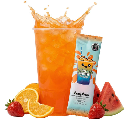 Candy Crush energy drink in a tall glass with ice, surrounded by orange slices, strawberries, and watermelon slices.