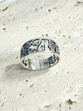 Silver 925 lucky charm ring with protection symbols, handmade in Mexico, featuring intricate cut-out designs on a textured