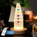 The Stress Shield Lamp - 7 Stones of Healing features a tiered wooden base with seven colorful healing stones, illuminated