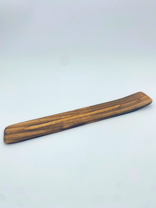 Traditional Wood Incense Holder made of smooth, dark brown wood with a small hole for incense stick placement.