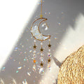 Crystal Moon Suncatchers hanging ornament with gold crescent moon, star and crystal beads, creating rainbow reflections on a