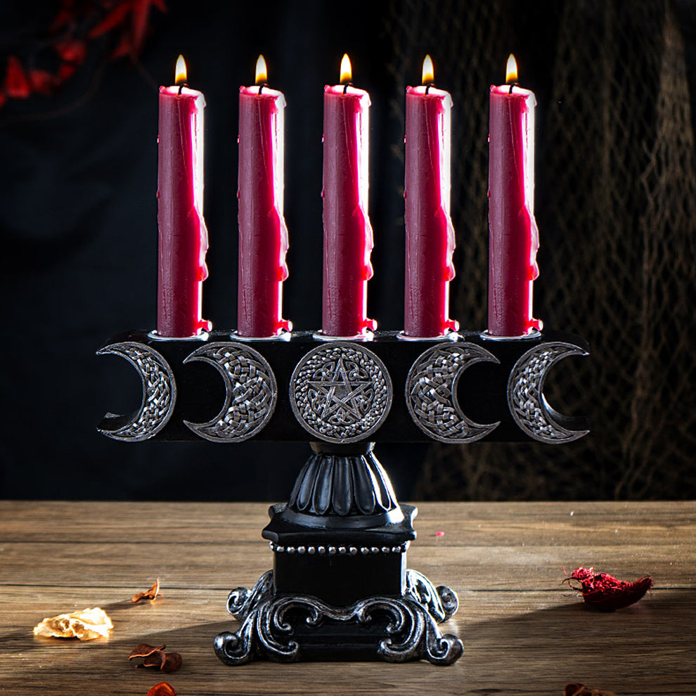 Triple Moon Pentagram 5 Candle Holder with five lit red candles on a black ornate base, featuring crescent moon and