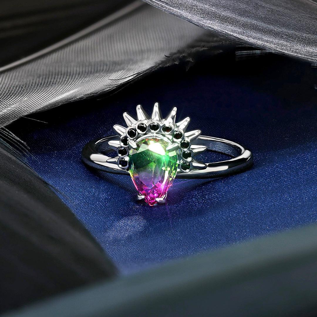 Wicked Witch of the West Jewel Candle ring with a multicolored teardrop gemstone in green and pink hues, surrounded by