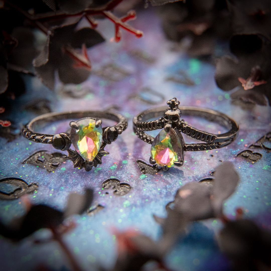 Wicked Witch of the West - Jewel Candle rings with iridescent teardrop-shaped crystals and black metal bands on a colorful