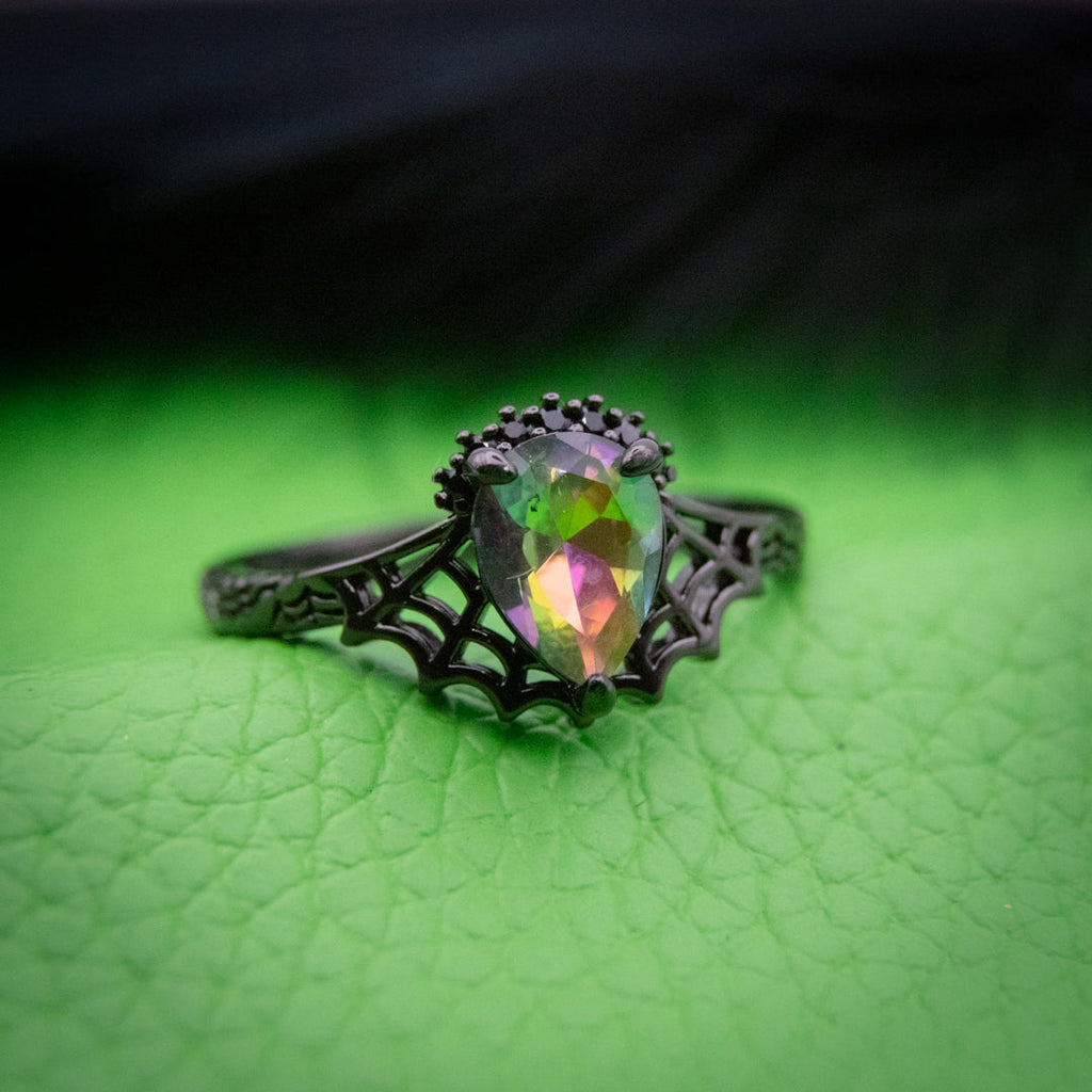 Wicked Witch of the West Jewel Candle ring with a black spiderweb design and a large iridescent gemstone centerpiece.