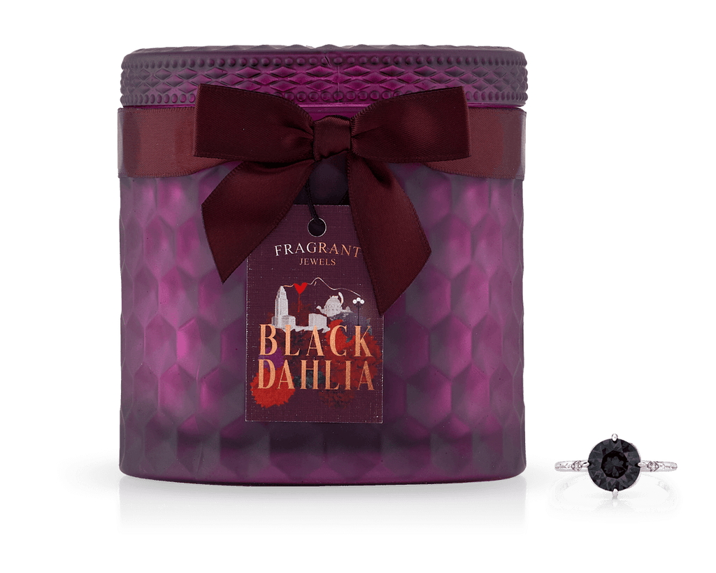 Black Dahlia Satin Collection Jewel Candle with a dark red ribbon bow and a black gemstone ring beside it.