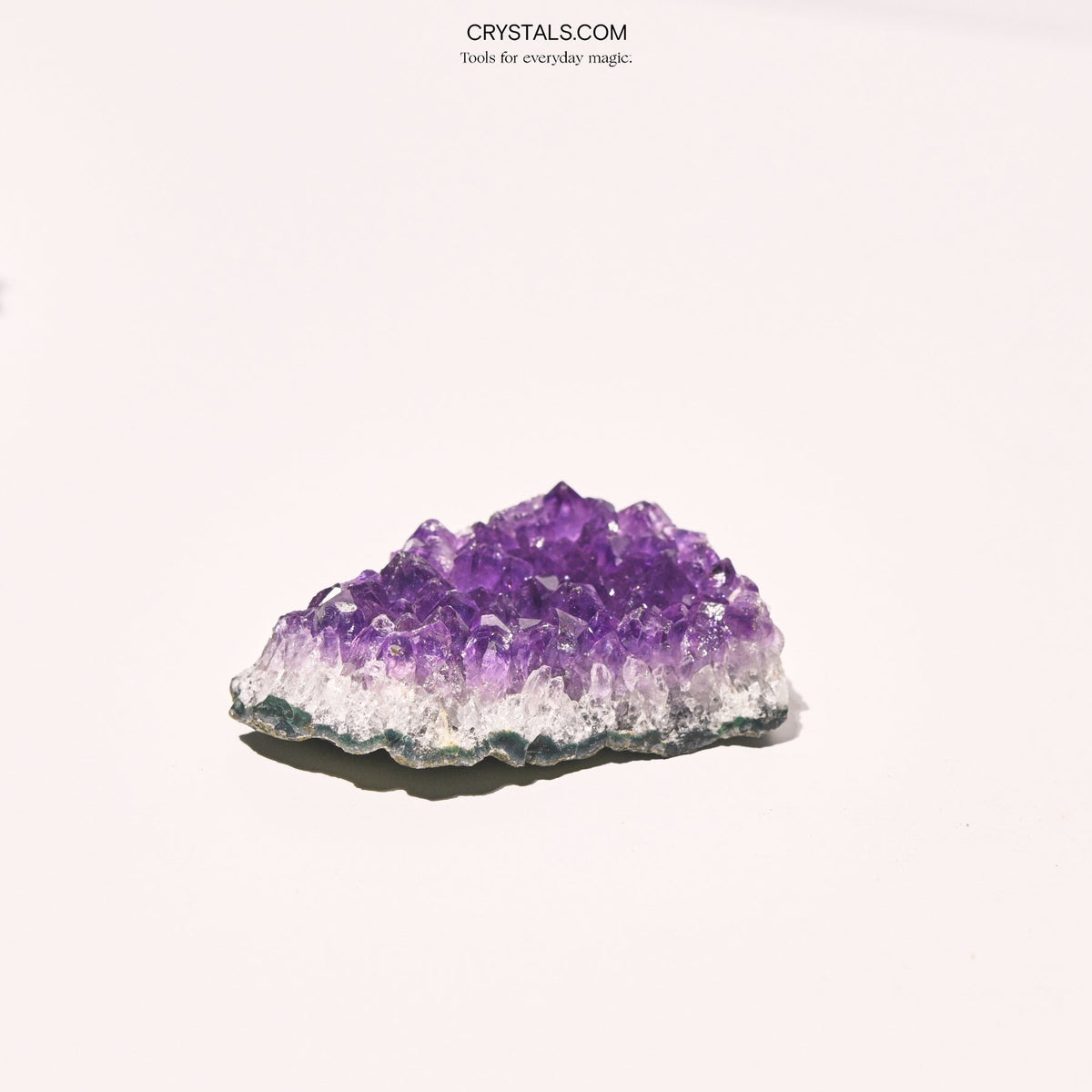 Amethyst Cluster with purple crystalline formations on a gray and white base, used for decoration or energy healing.