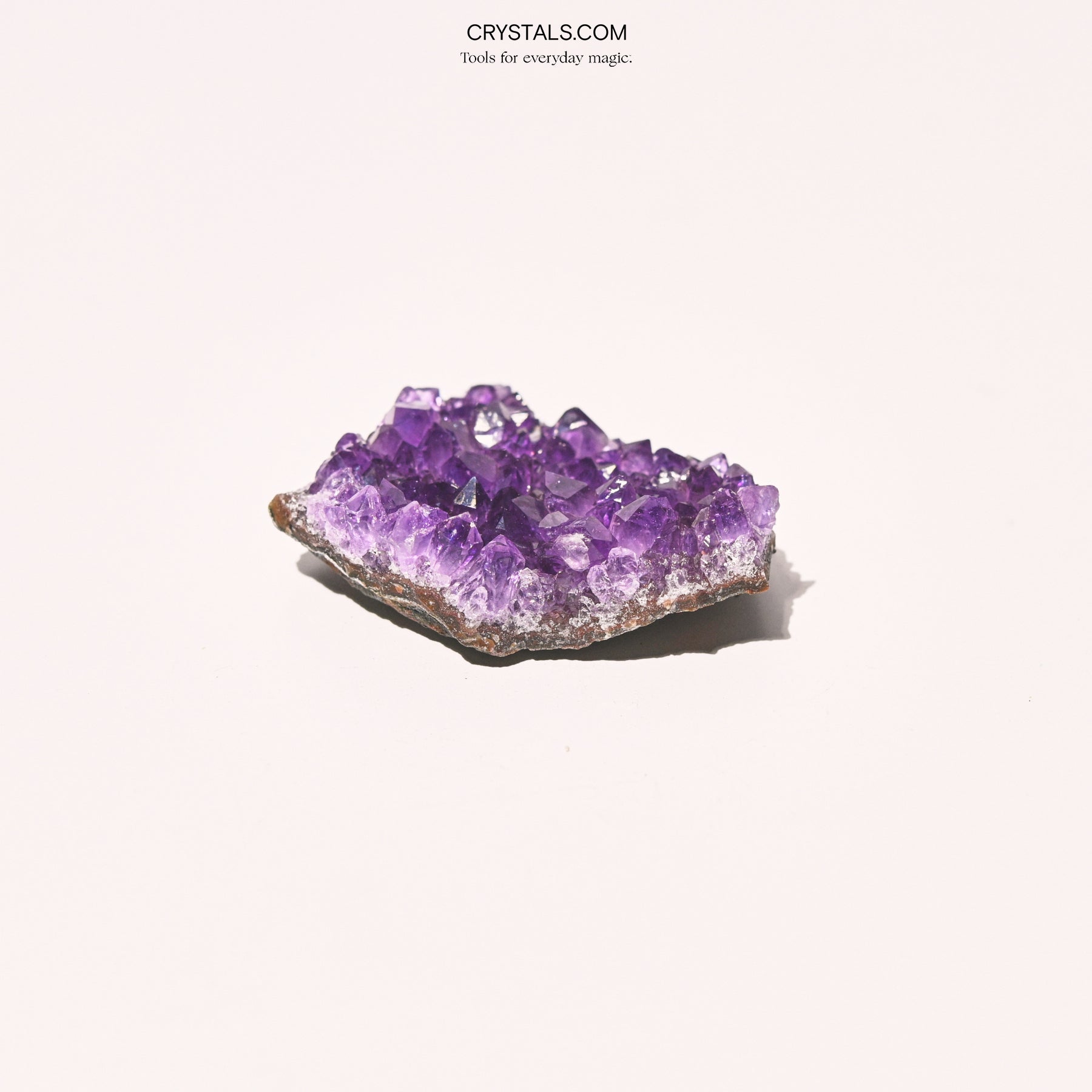 Amethyst Cluster with purple crystalline formations on a white background, showcasing natural mineral structure and vibrant