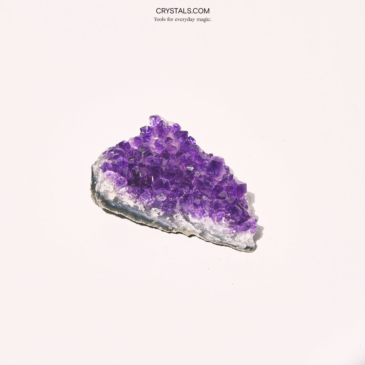 Amethyst Cluster with purple crystals on a white background, showcasing natural mineral formations for decorative or healing