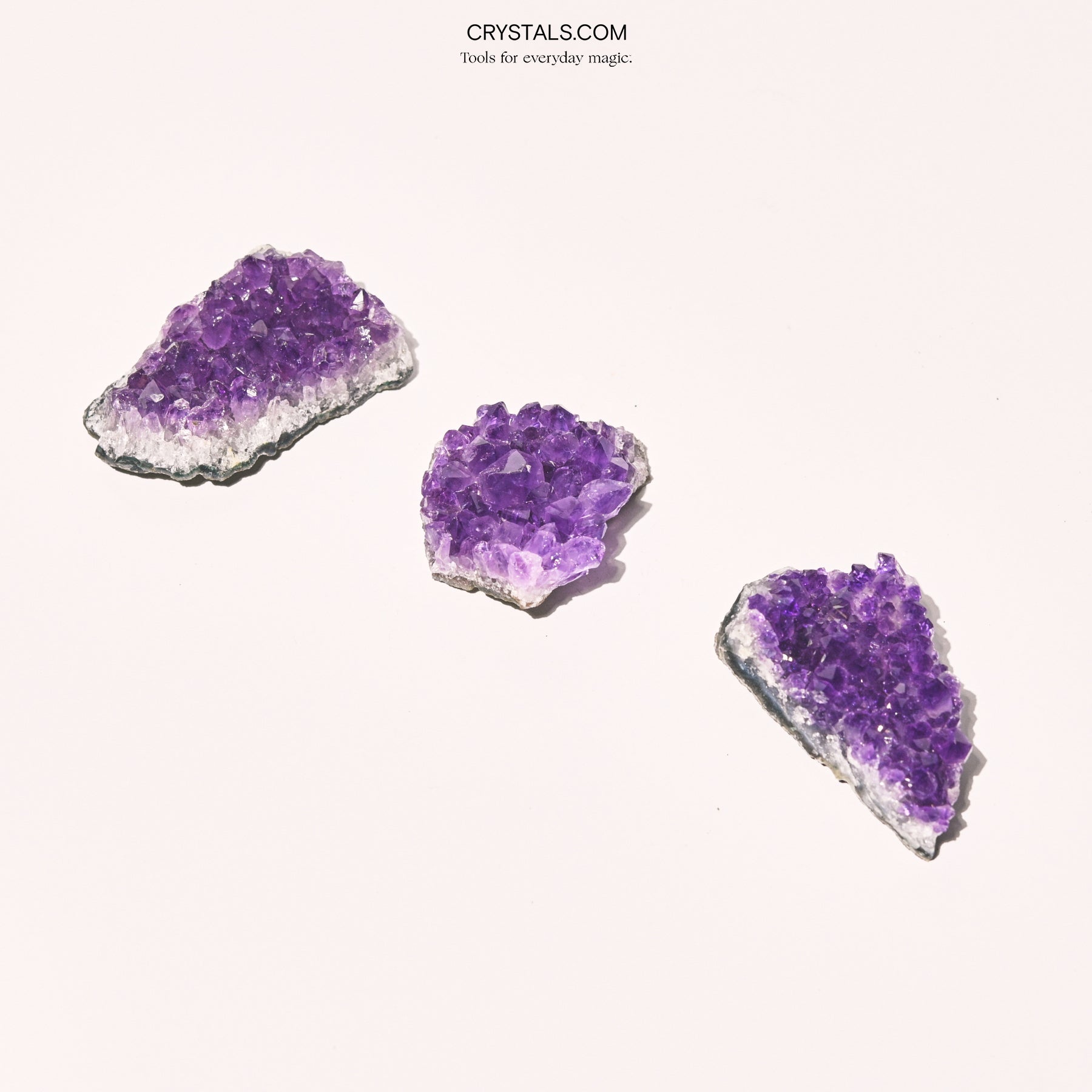 Amethyst Cluster with purple crystalline formations on a gray base, used for decoration or healing purposes.