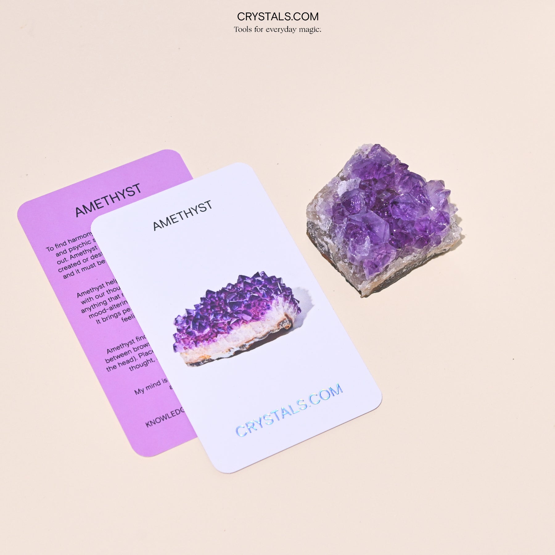 Amethyst Cluster with purple crystalline formations on a rough base, displayed alongside informational cards about amethyst.