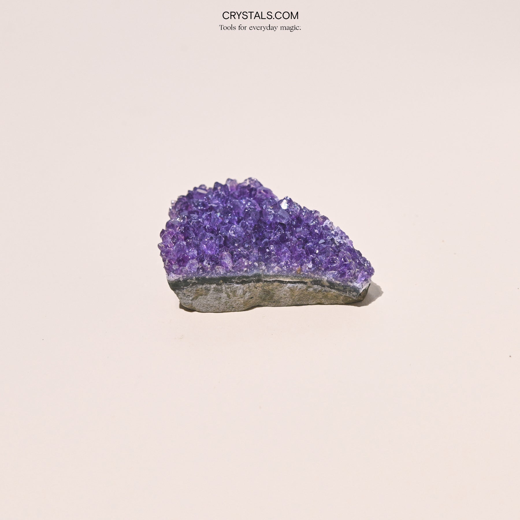 Amethyst Cluster with purple crystalline formations on a gray base, showcasing natural mineral beauty for decorative or