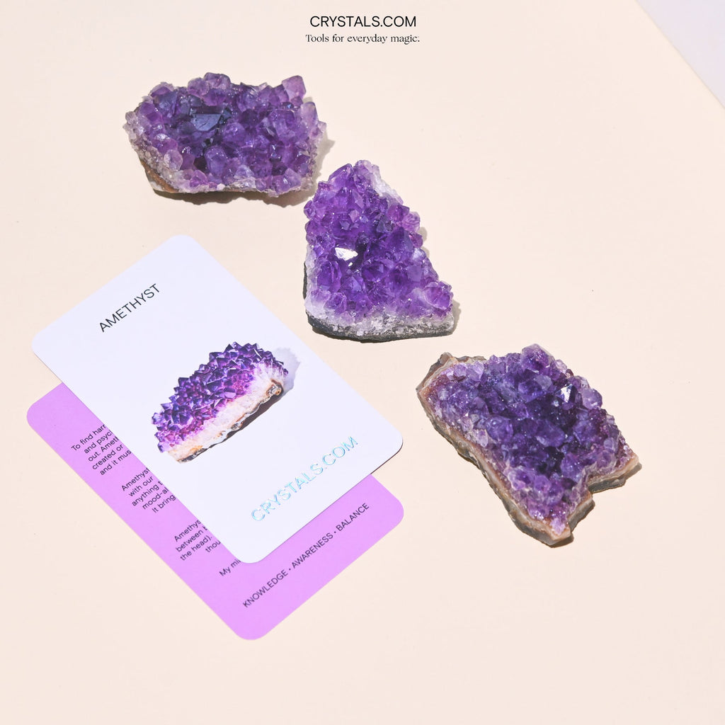 Amethyst Cluster with purple crystalline formations on a rough base, displayed alongside informational cards.