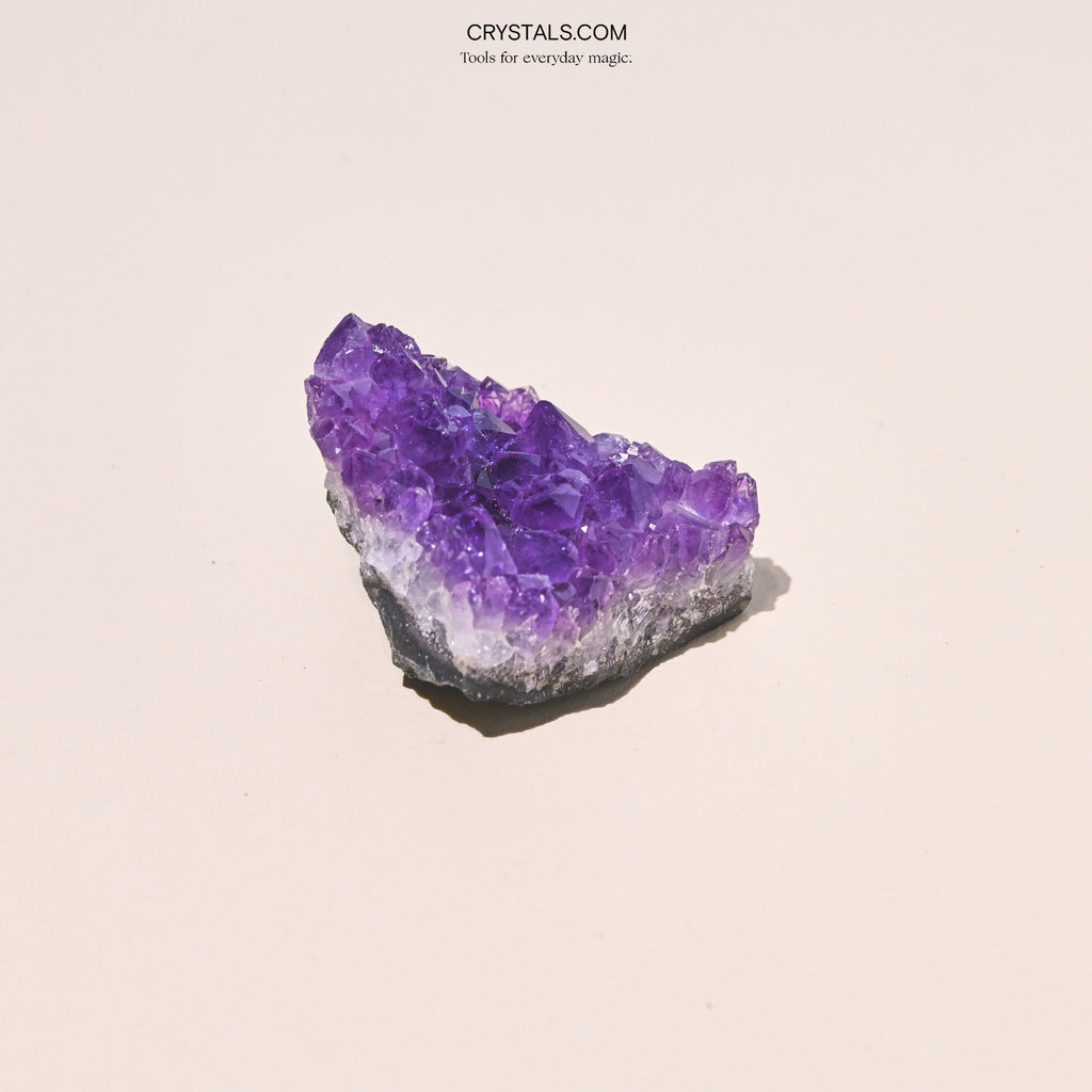 Amethyst Cluster with purple crystalline formations on a gray base.