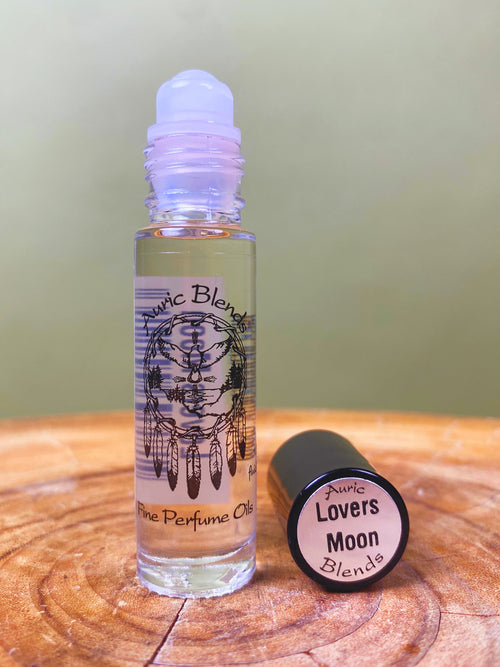 Lovers Moon Roll-on Perfume Oil in a clear glass bottle with a white rollerball, featuring a black and white dreamcatcher