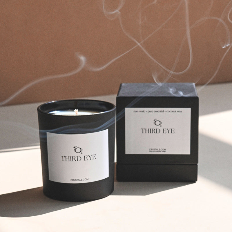 Third Eye Candle in a black glass container with minimalist label, accompanied by black packaging box, designed for