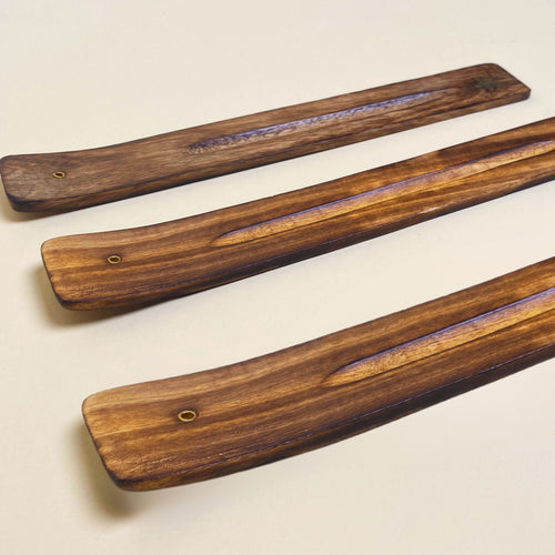 Traditional wood incense holder with a natural brown finish and a carved slot for incense sticks.