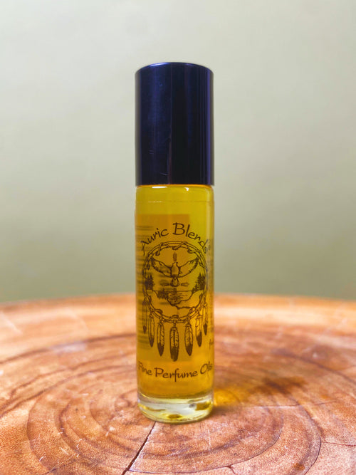 Plumeria Roll-on Perfume Oil in a small glass bottle with a black cap, yellow label with a dreamcatcher design, and floral
