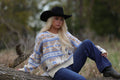 Main Strip Southwestern Knit Sweater — Oversized V-Neck with bold blue, tan, and cream geometric print, worn with dark jeans